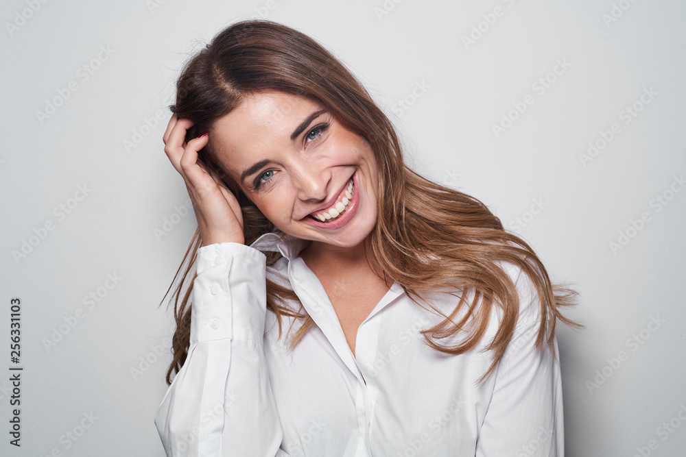Portrait of laughing young woman wearing white blouse Portrait of laughing young woman wearing white blouse