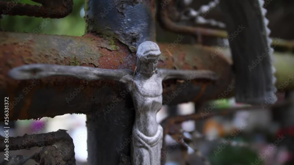 Old Rusty Metal Crucifix on Forgotten Grave in Cemetery Old Rusty Metal Crucifix on Forgotten Grave in Cemetery