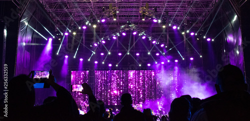 Group of people in outdoor concert, illuminated stage, high technology, powerful sound, latin america, fun, work, latin america.