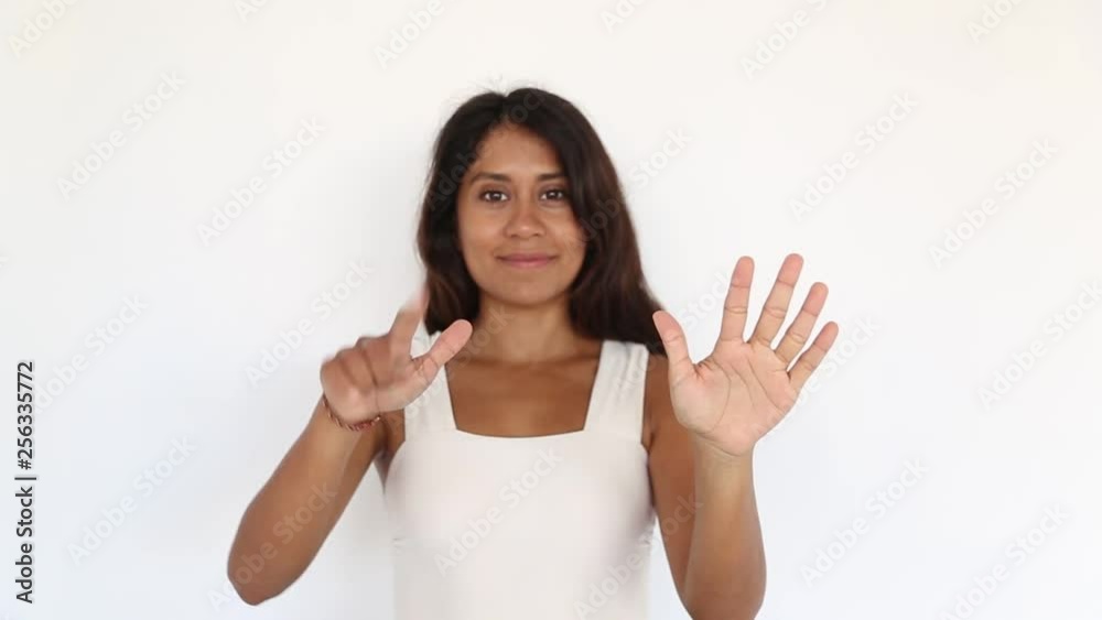Pretty young woman shows counting from one till ten. Pretty young woman shows counting from one till ten.