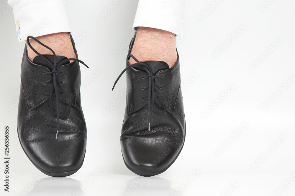 Classic shoes worn on the hands on a white background