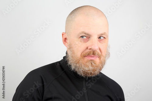 Portrait of a bald and bearded happy man