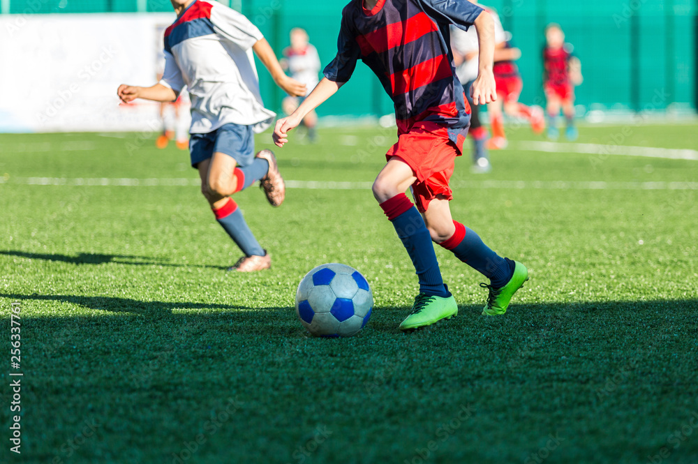 Football training soccer for kids. Boy runs kicks dribbles soccer balls. Young footballers dribble and kick football ball in game. Training, active lifestyle, sport, children activity concept 