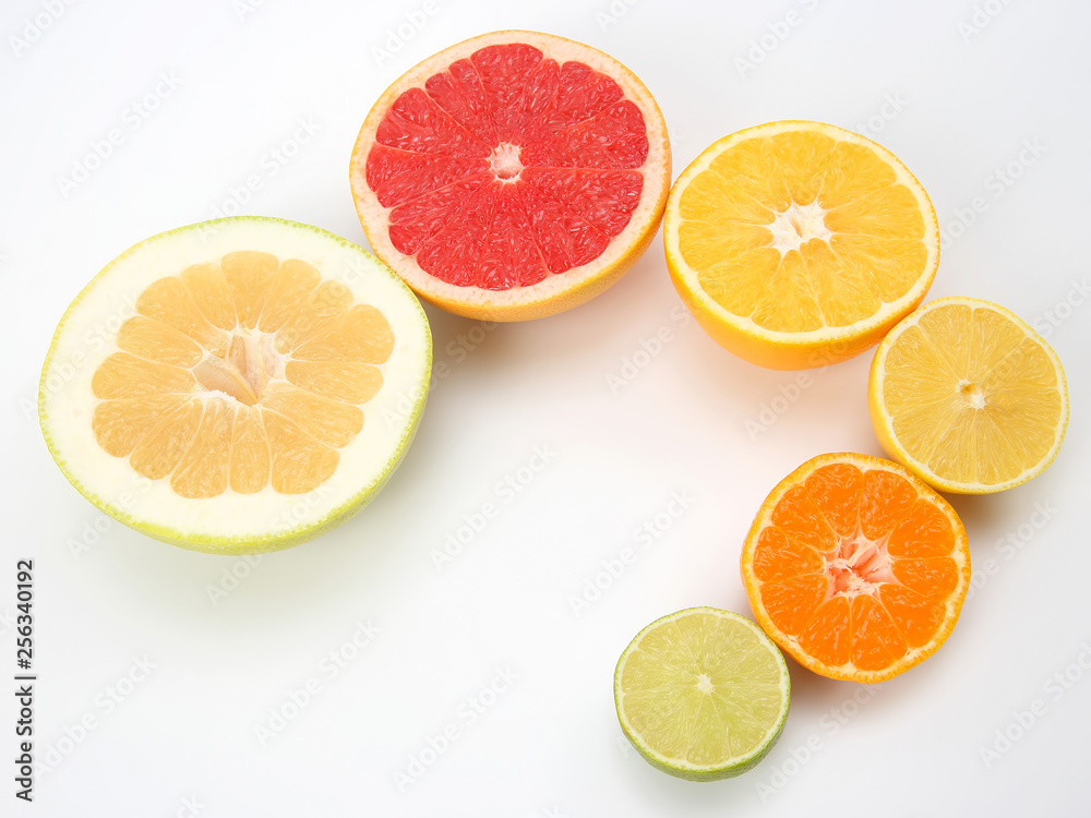 cut pieces of different citrus fruits on white background cut pieces of different citrus fruits on white background