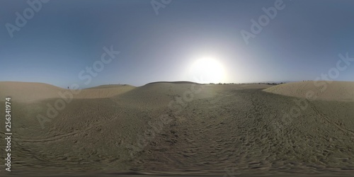 360 VR Video. Vast sandy landscape of Maspalomas Dunes with several people walking there. Man with backpack  with model release  enjoying the view from sandhill