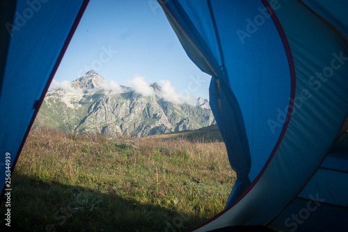 the best view from the window is the view from the tent to the beautiful snow-capped mountains above the clouds on a sunny morning