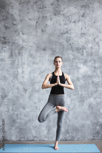 Yoga woman tree pose.