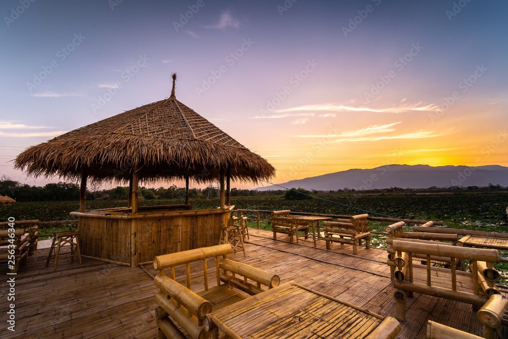 Twilight at the reservoir with bamboo pavilion and reflection in sunset, Chiang Mai in Thailand