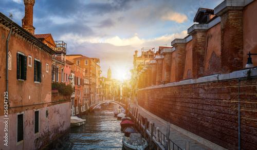 Fototapeta Naklejka Na Ścianę i Meble -  View of the street canal in Venice, Italy. Colorful facades of old Venice houses. Venice is a popular tourist destination of Europe. Venice, Italy.