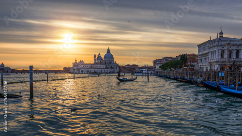 Sunset in Venice. Image of Grand Canal in Venice, with Santa Maria della Salute Basilica in the background. Venice is a popular tourist destination of Europe. Venice, Italy.