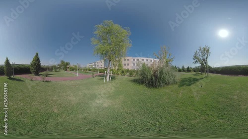 360 VR Video. Hotel building and garden with paths, green lawns and hedges. Resort in Nea Kallikratia, Greece photo