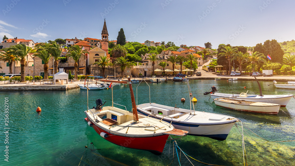 Fishing boats in Splitska village with beautiful port, Brac island, Croatia. Village of Splitska on Brac island seafront view, Dalmatia, Croatia, Croatia.