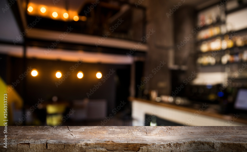 blurred background of bar and dark brown desk space of retro wood