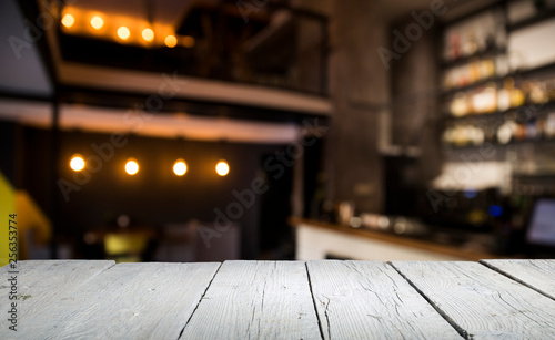 blurred background of bar and dark brown desk space of retro wood