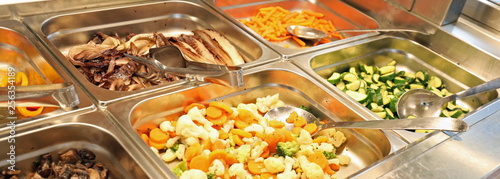 Tableau sur toile steel trays with plenty of vegetables cooked and raw in the cafe