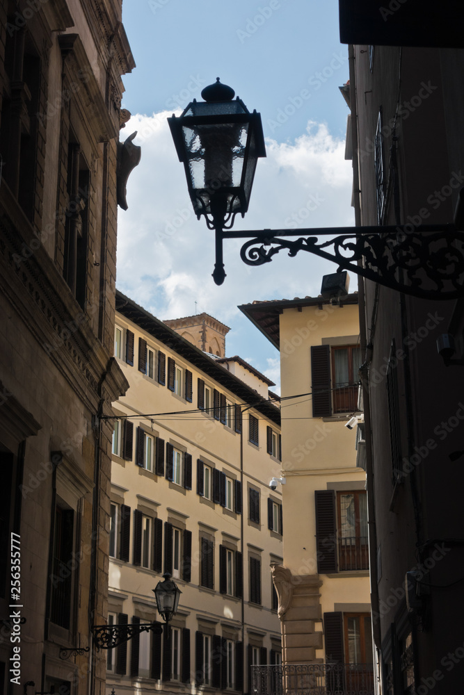 Romantic alley with decorative lanterns at downtown of Florence in Tuscany, Italy