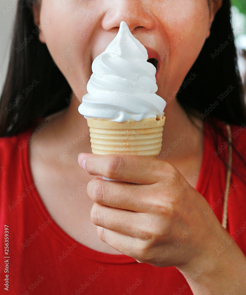 Closeup of female mouth eating an ice-cream.