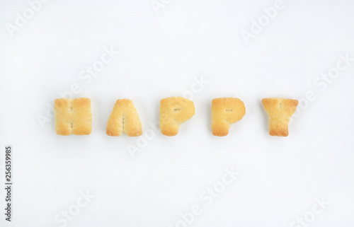 Text "HAPPY" from cookies on white background.