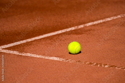 A lonely Tennis Ball on a Sand Court © Augustas Cetkauskas