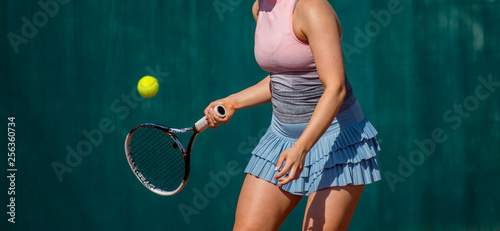 Tennis player playing a match on the court on a sunny day © Augustas Cetkauskas