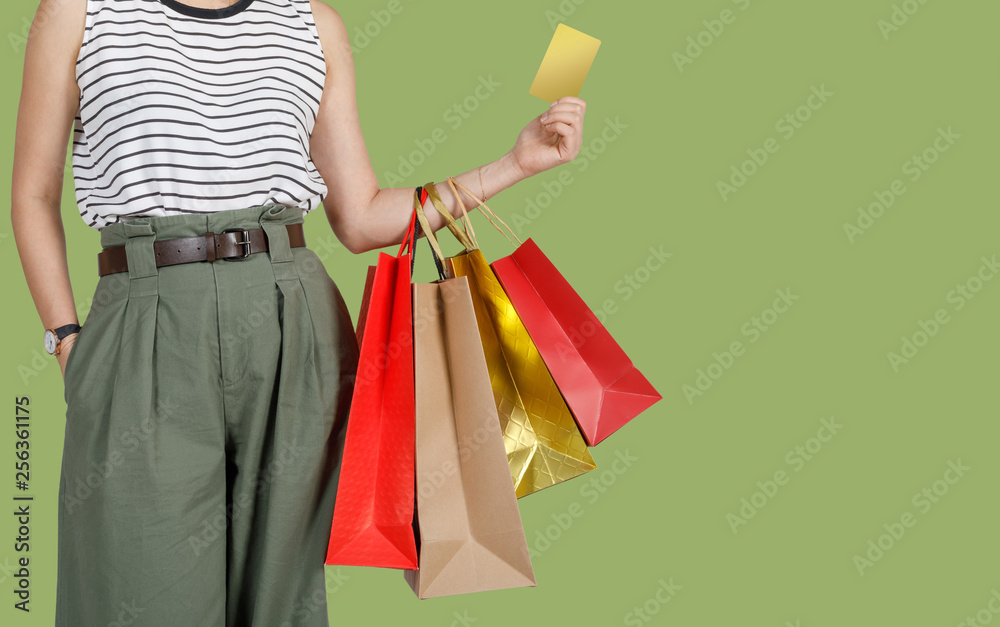 Shopping woman holding shopping bags and credit card in green background, Copy space for your text, E-commerce digital marketing lifestyle concept