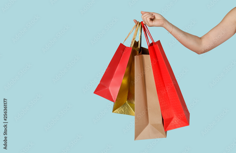 Shopping woman holding shopping bags in blue background, Copy space for your text, E-commerce digital marketing lifestyle concept