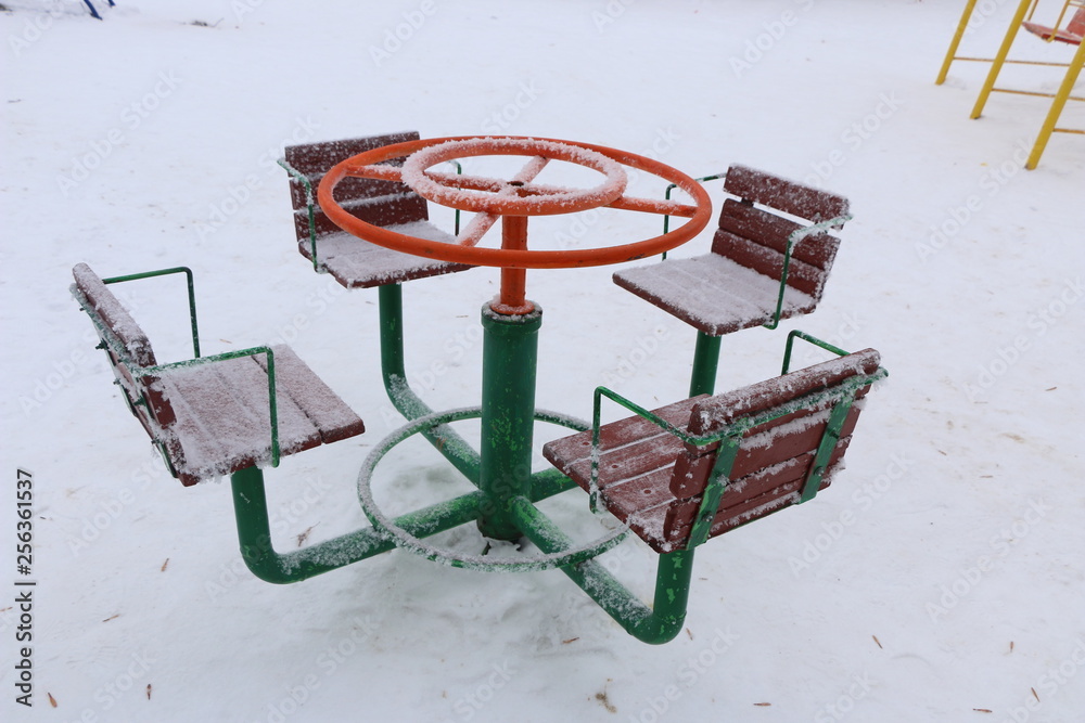 playground with swings, benches, slide and sports units in snow. playground with swings, benches, slide and sports units in snow.