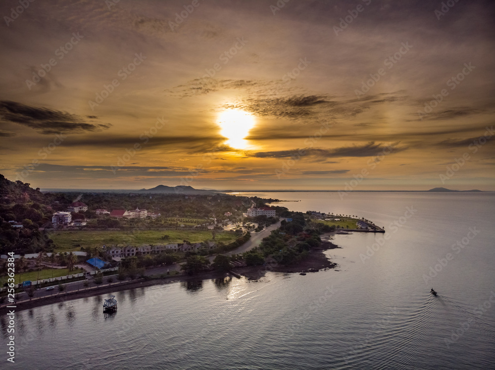 Aerial shot of Kep in Cambodia shot with a rising sun and fishing boat returning to shore.