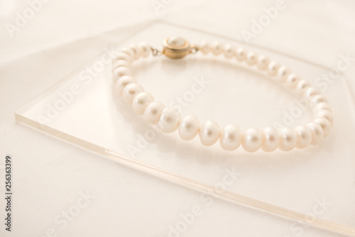 Pearl bracelet on a reflective surface