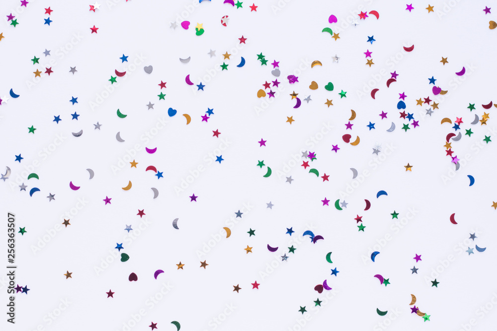 colored sequins of different shapes on white background colored sequins of different shapes on white background