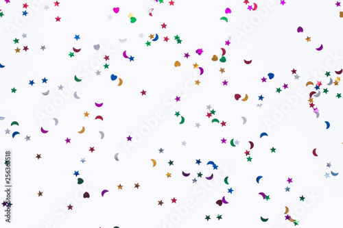 colored sequins of different shapes on white background