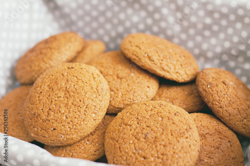 Fresh oatmeal cookies on light-colored fabric