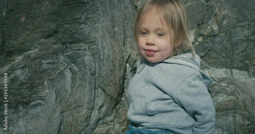 Little toddler climbing on rocks Little toddler climbing on rocks