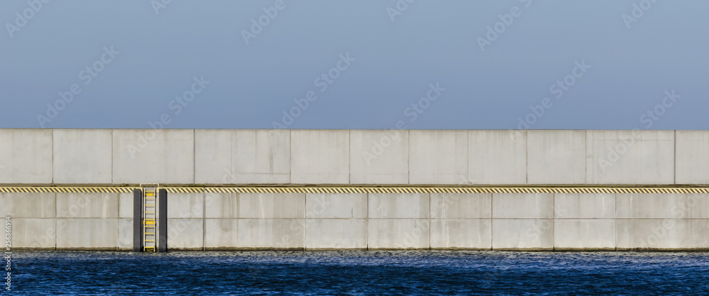 Fototapeta premium SEAPORT BREAKWATER - Concrete wall and ladder