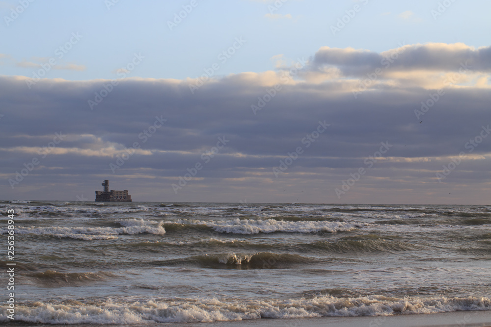 sea with waves against a cloudy sky
