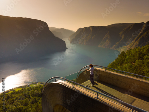 Tourist enjoying fjord view on Stegastein viewpoint Norway photo