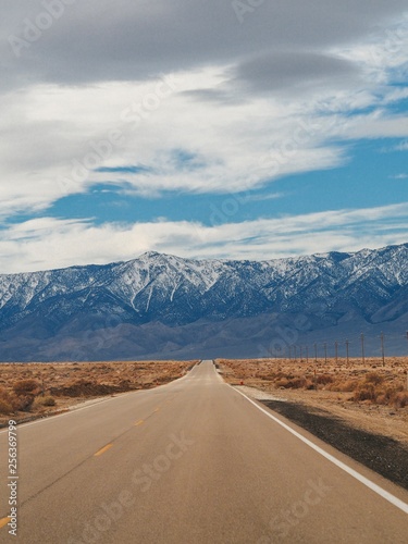 Wide open empty highway through Death valley, California, mountain view