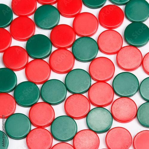 Abstract background of red and green plastic round pieces. Plastic items background