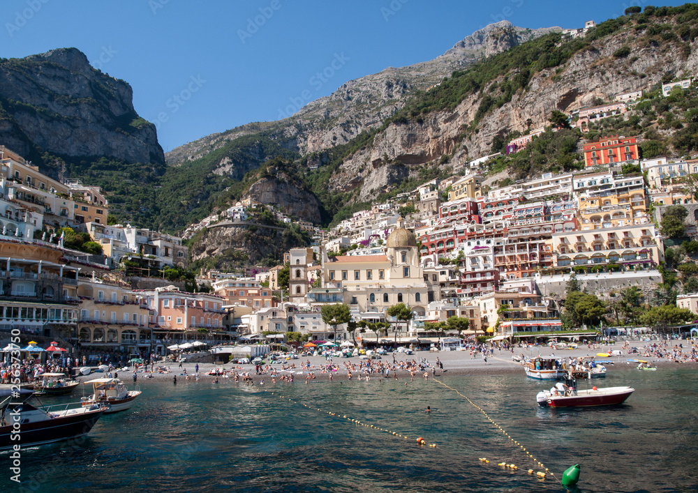  People are resting on a sunny day at the beach in Positano on Amalfi Coast in the region Campania, Italy