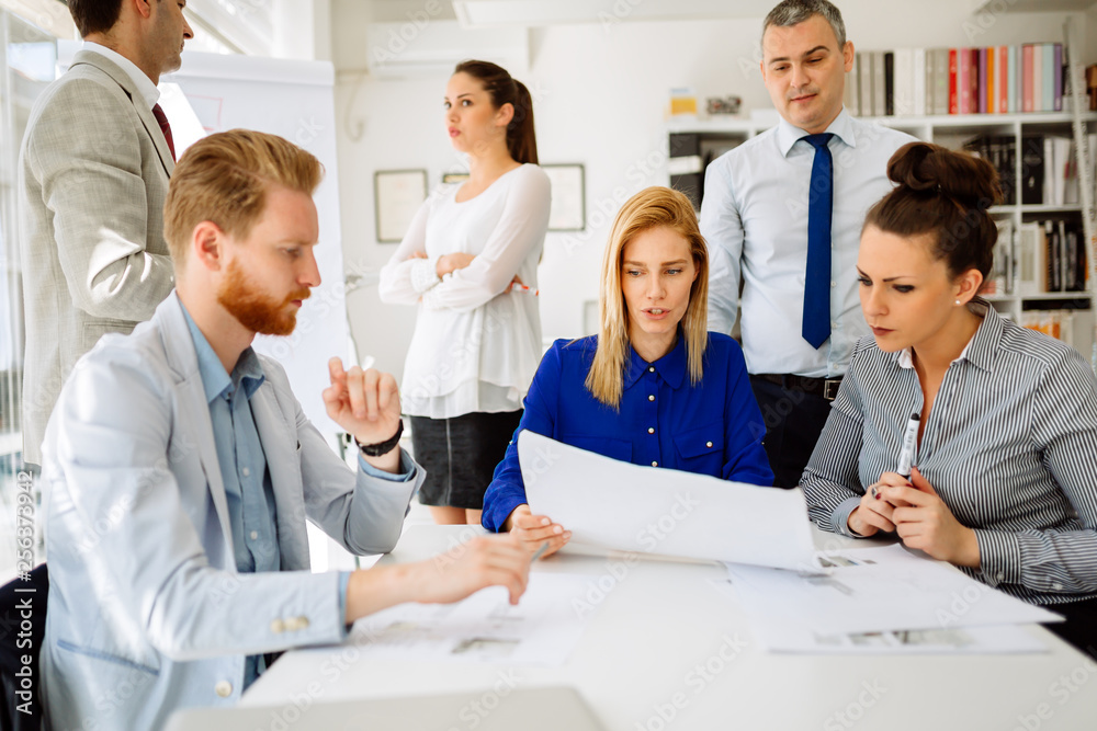 Group of business people working as team in office Group of business people working as team in office