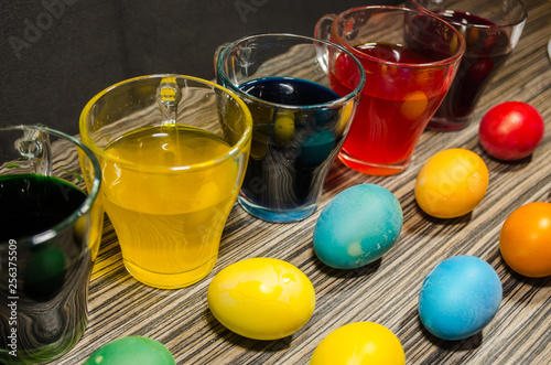 cups with colored water and easter eggs