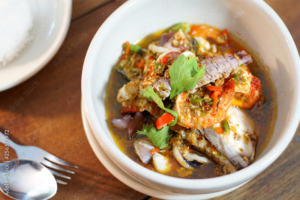 Pad Cha Tha Leh or Spicy Fried Seafood is Stired Hot&Spicy herb with fish, shrimp and squid. Served with steamed rice, Selective focus. Still life shoot in studio, Clean food good taste concept. Pad Cha Tha Leh or Spicy Fried Seafood is Stired Hot&Spicy herb with fish, shrimp and squid. Served with steamed rice, Selective focus. Still life shoot in studio, Clean food good taste concept.
