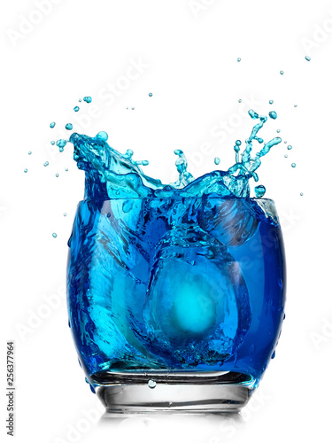 Painting blue Easter egg in a glass