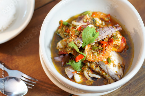 Pad Cha Tha Leh or Spicy Fried Seafood is Stired Hot&Spicy herb with fish, shrimp and squid. Served with steamed rice, Selective focus. Still life shoot in studio, Clean food good taste concept.