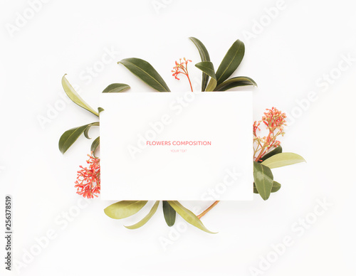 Fototapeta Naklejka Na Ścianę i Meble -  Minimal composition with a paper white blank card and flower on a white background. Mockup with blank card. Flat lay. Top view.