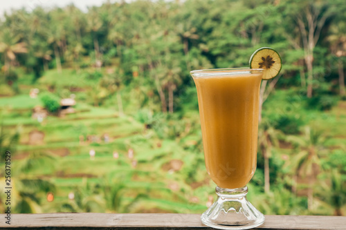 fresh mango juice on a background of rainforest
