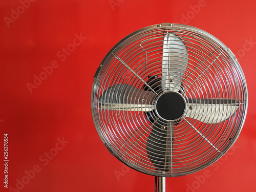Electric fan with red background.