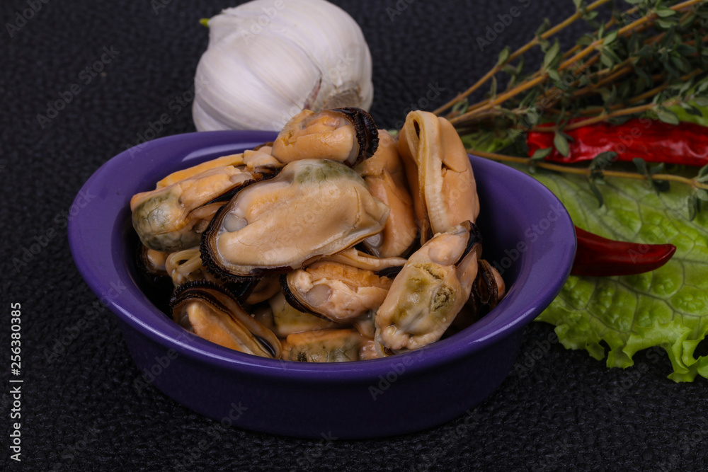Pickled mussels in the bowl served pepper, garlic and salad Pickled mussels in the bowl served pepper, garlic and salad