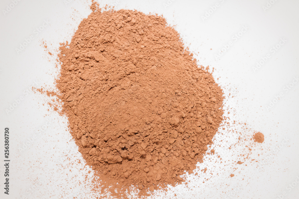 Dry cocoa powder poured in a mixing bowl Dry cocoa powder poured in a mixing bowl