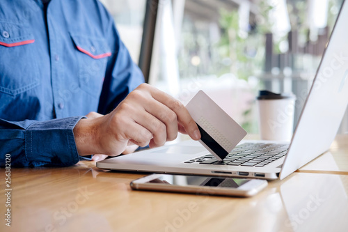 Businessman holding credit card and typing on laptop for online shopping and payment makes a purchase on the Internet, Online payment, Business financial and technology